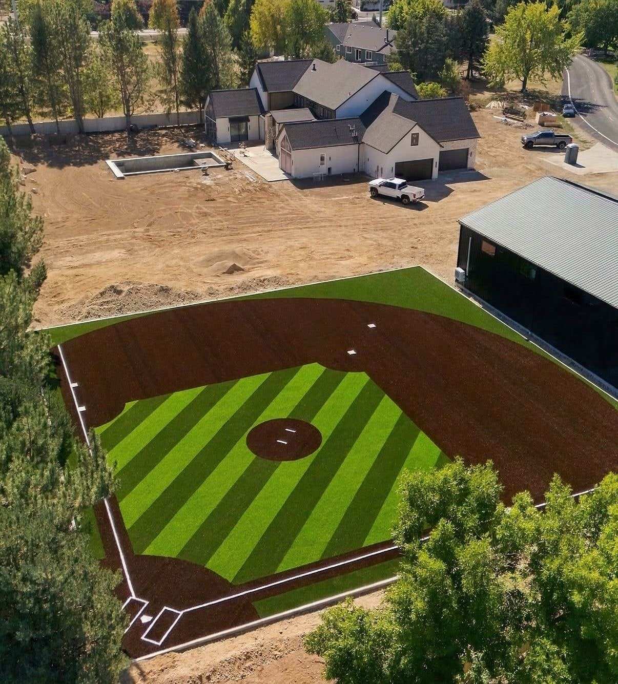 Backyard baseball field with a striped artificial turf outfield