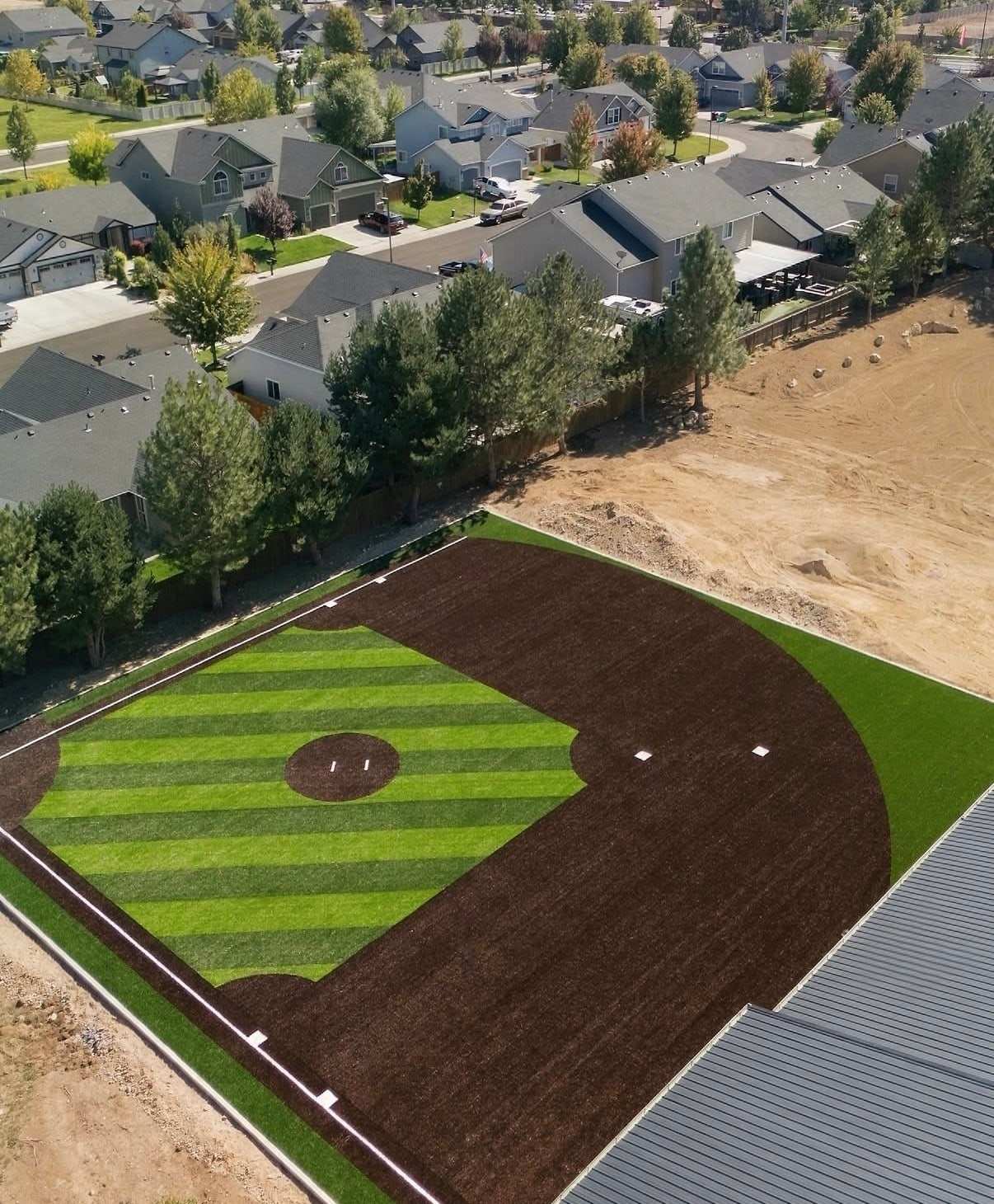 Private backyard baseball field with striped turf