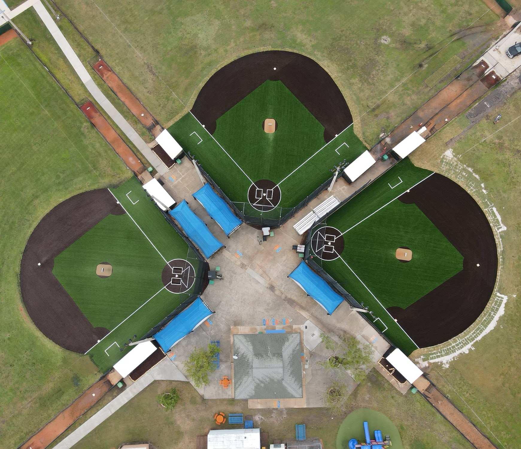 Overhead view of a four-field baseball complex with turf infields