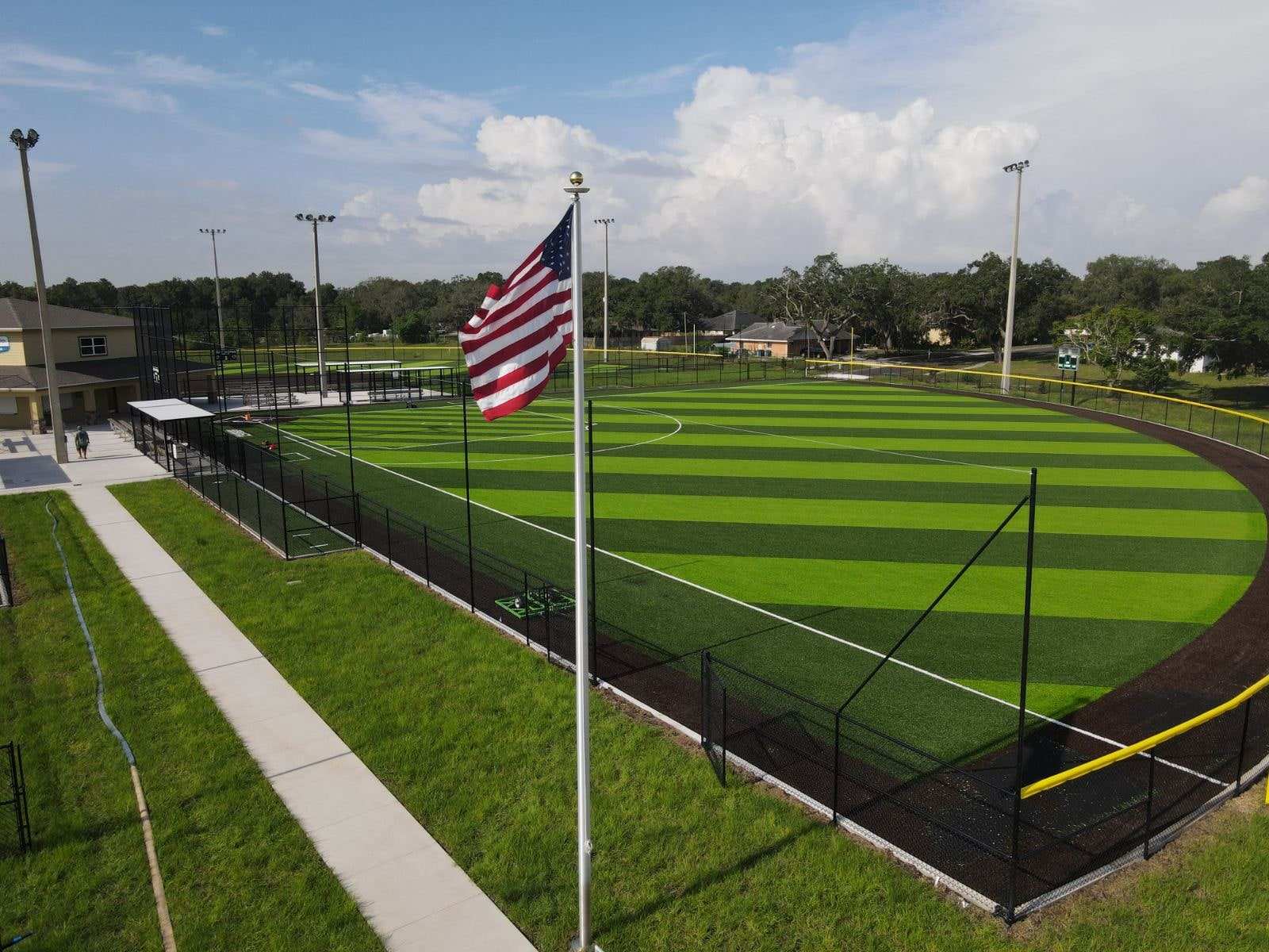 Striped ballfield with an American flag