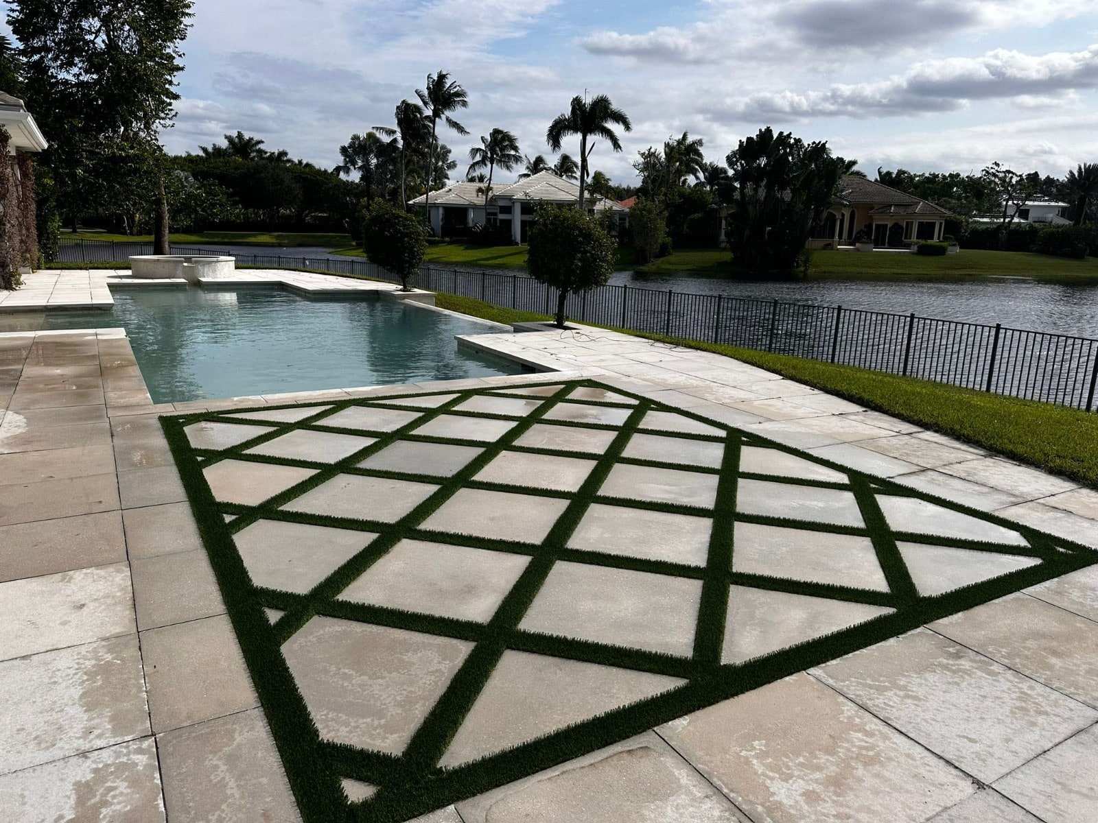 Turf strips set between pool deck pavers