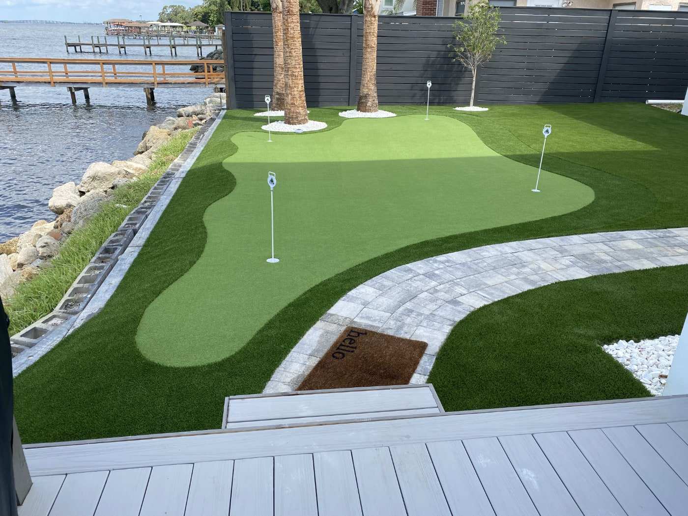 Backyard putting green beside the water