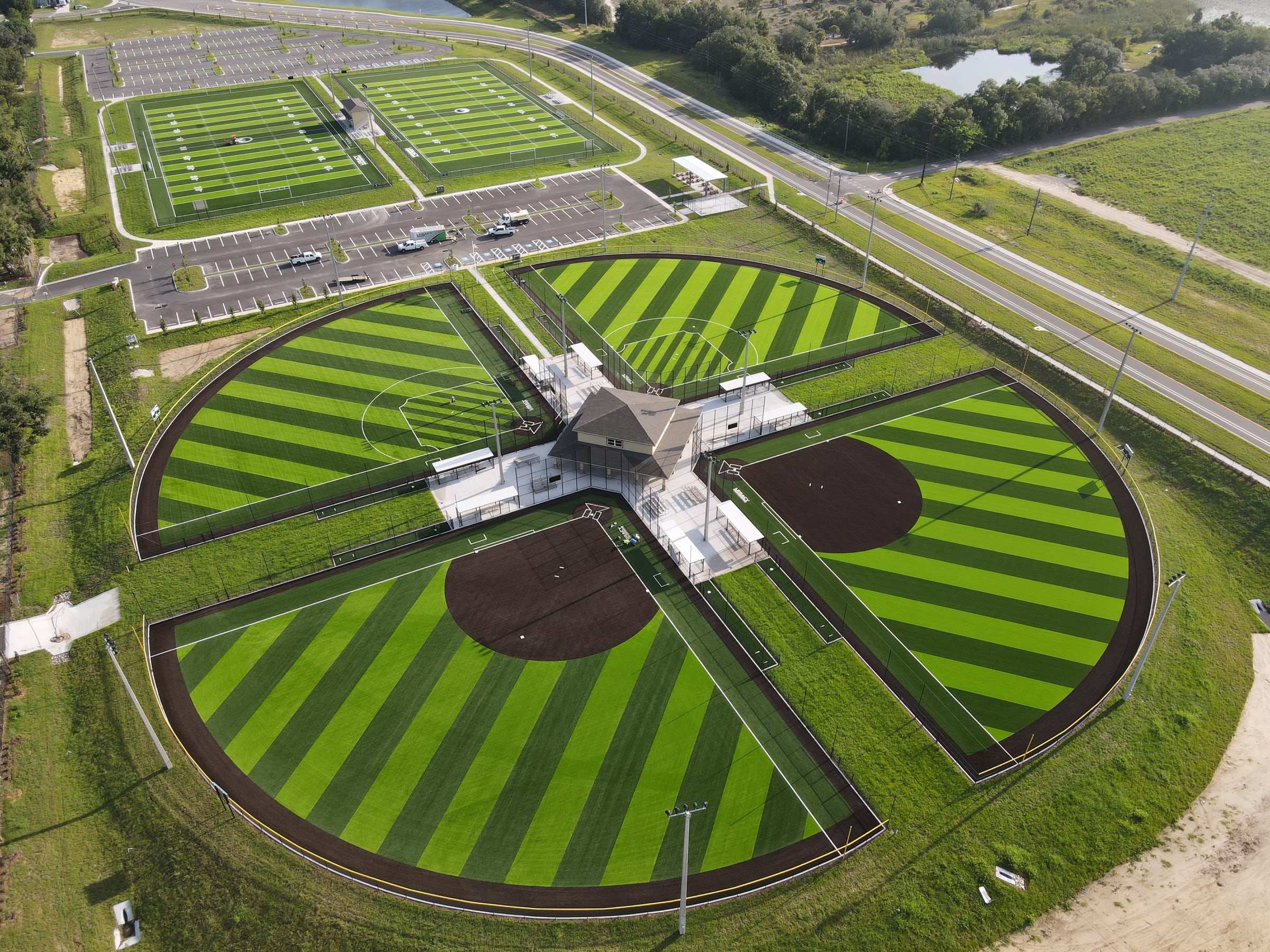 Aerial view of a four-field softball complex with striped turf