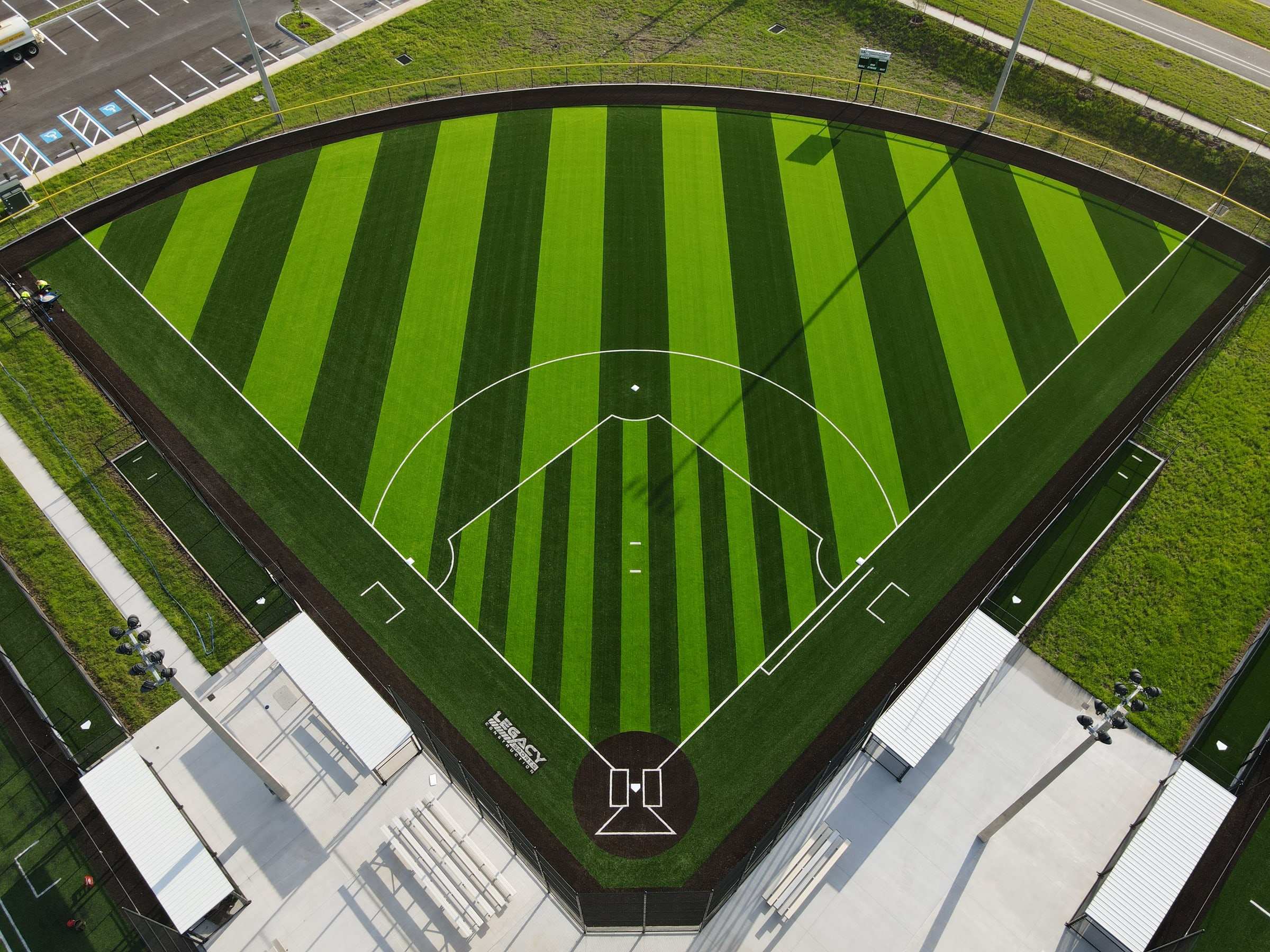 Striped turf softball field with covered dugouts