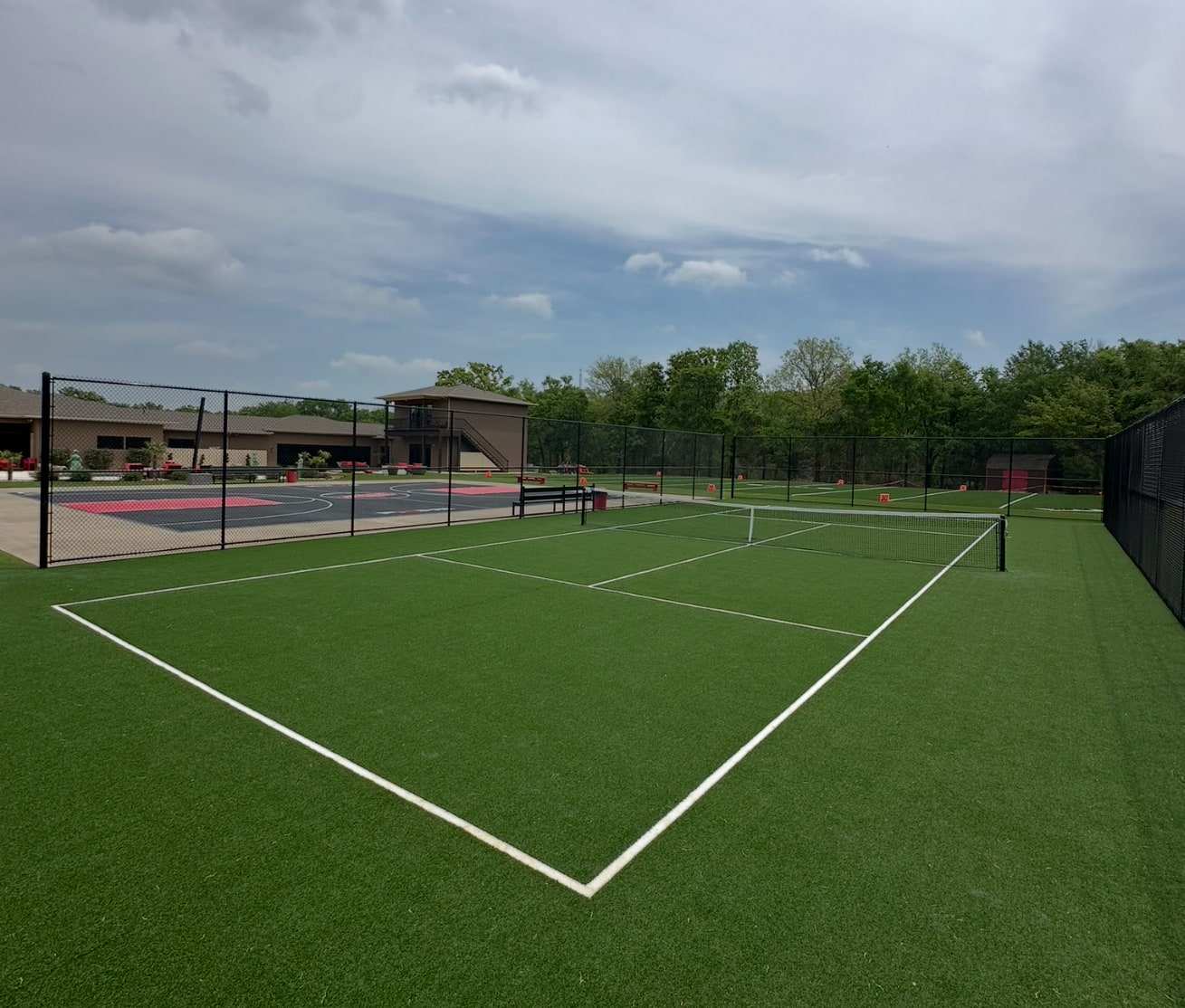 Backyard sport court surfaced with turf